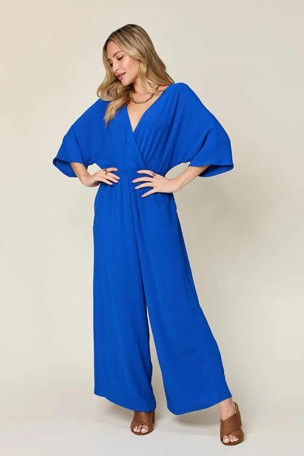 Double Take Full Size Surplice Wide Leg Jumpsuit with Pockets by Trendsi